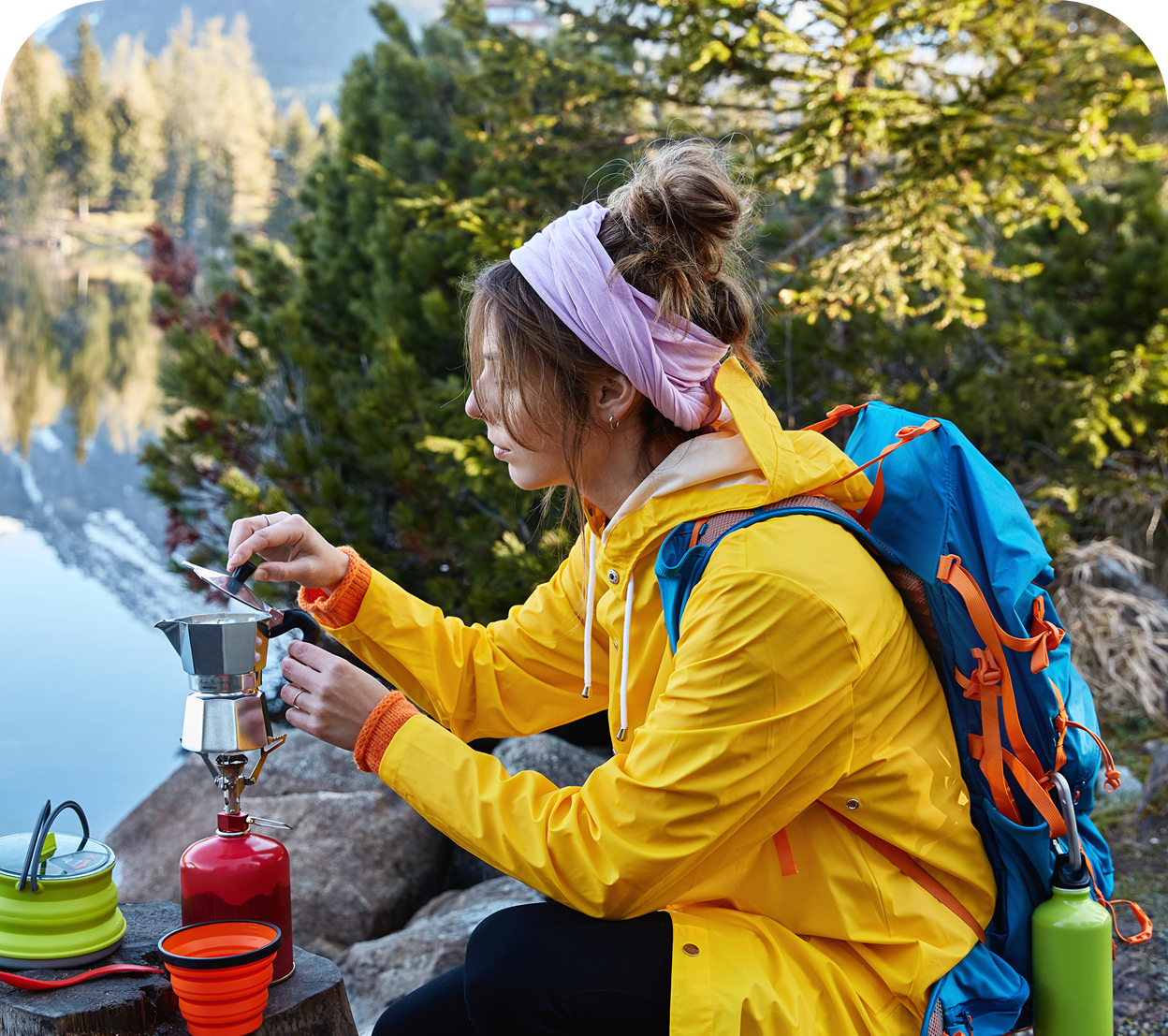 restful female traveler makes coffee camping stove poses near stump has break after wandering e1758693392920