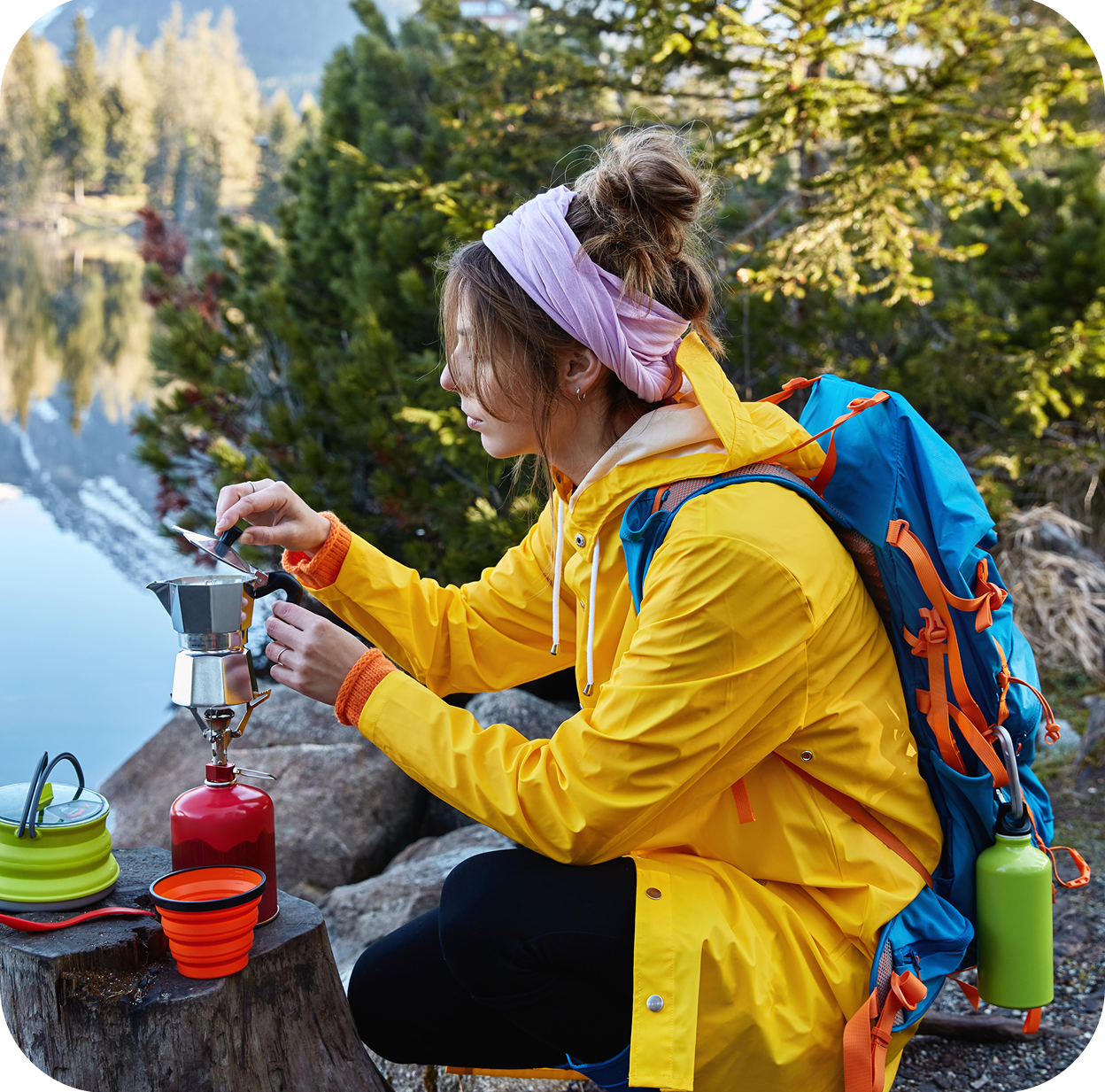 restful female traveler makes coffee camping stove poses near stump has break after wandering e1758695280840