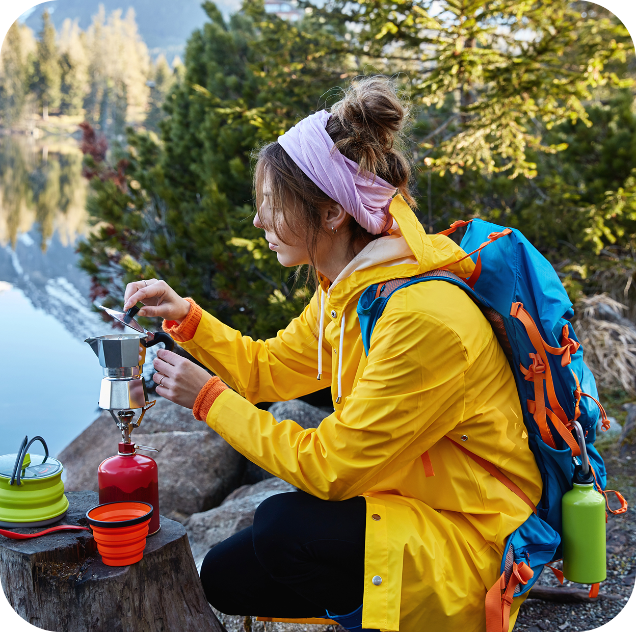 restful female traveler makes coffee camping stove poses near stump has break after wandering